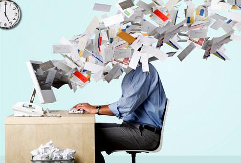 man working at a desktop with physical mail flying out of the screen and into his face. LOTS of mail.