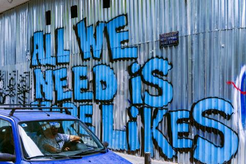 All We Need is More Likes graphitti on a metal wall