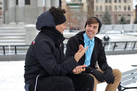 Person giving advice to another person outside in winter