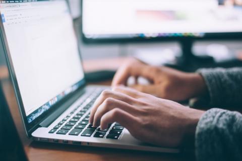 Closeup of a developer working on a laptop