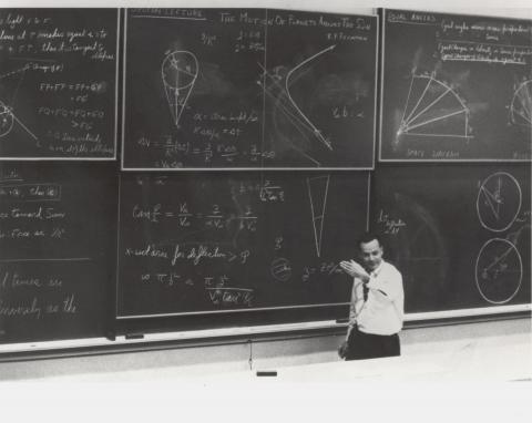College professor in front of massive blackboard array