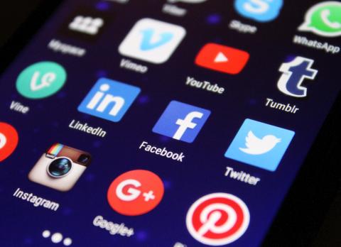 Mobile device screen full of social media icons