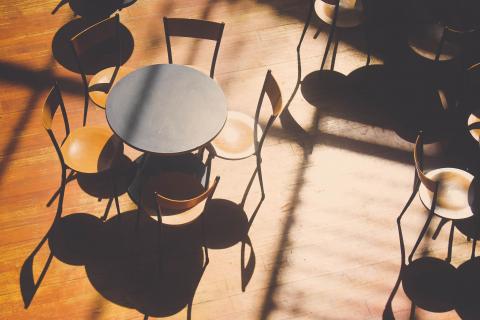 Wooden tables and chairs arranged on a wood floor