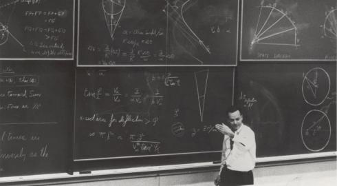 College professor in front of massive blackboard array