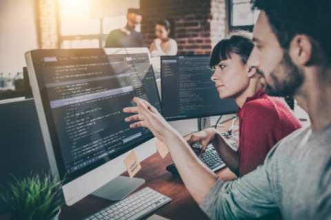 Two people building a website in an office